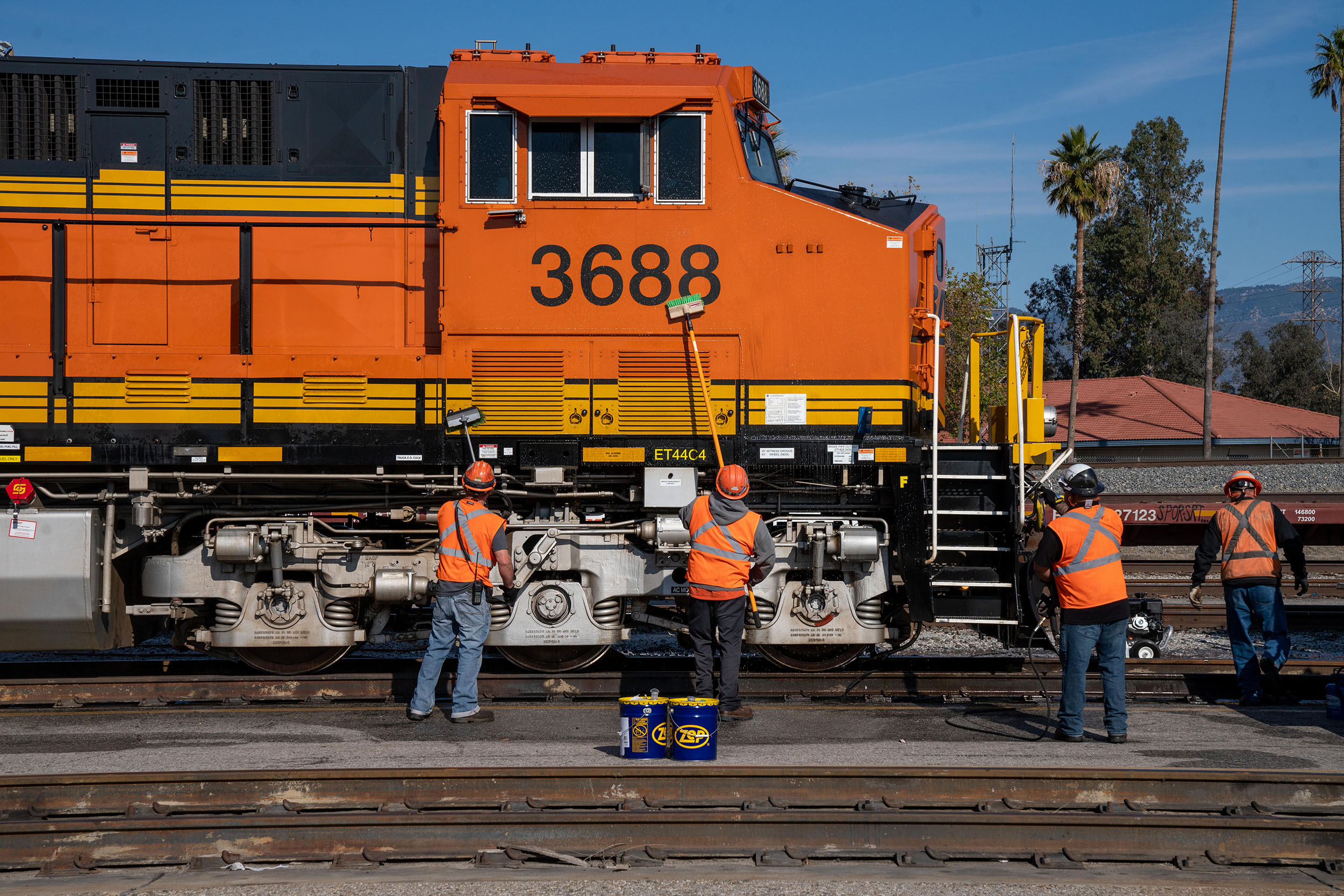 Yard crew washing a locomotive parked at the San Bernardino Intermodal Facility in San Bernardino, California.