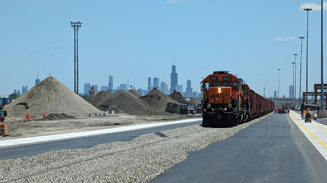A train brings in ballast rock to support the construction of the new 4,530-foot production track. A train brings in ballast rock to support the construction of the new 4,530-foot production track.